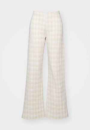 Light yellow checkered wide-leg trousers made of textured fabric, featuring a high waist and flowing silhouette, suitable for casual wear.