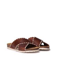 Brown leather sandals with cross-over straps, white stitching, and speckled rubber soles. Open-toe design for comfort.