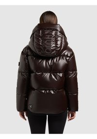 Brun glansig vadderad jacka med stor huva och logodetalj på kragen. Har horisontell sömnad och en liten logotyp på fållen.