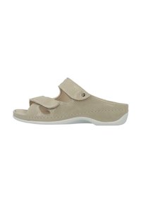 Beige slip-on sandal with textured upper, two adjustable straps, open toe design, and a cushioned sole with a white accent.