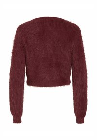 Pull court bordeaux en tissu pelucheux, avec de longues manches et des détails côtelés aux poignets et à l'encolure.
