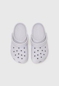 Light gray slip-on clogs made of lightweight material with ventilation holes and a textured footbed; features a back strap for secure fit.
