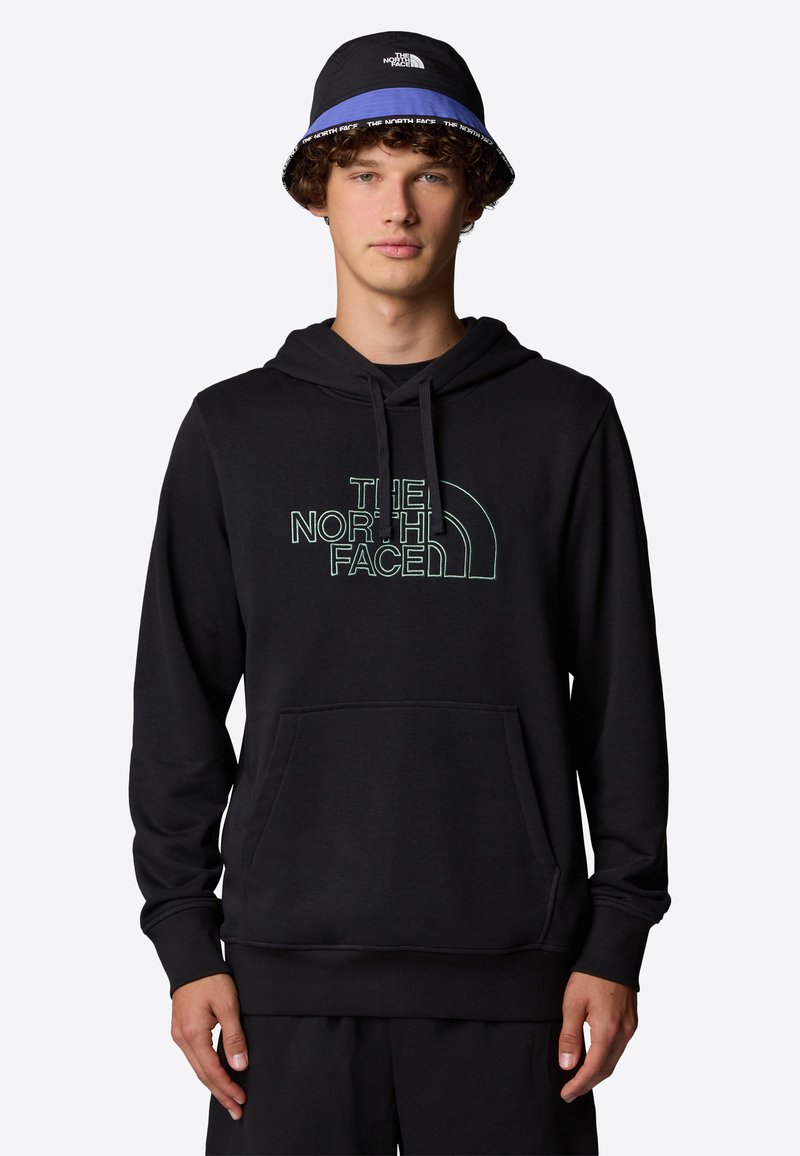 Black hoodie featuring a front pocket and hood, adorned with a green outlined logo. Worn with a black and blue bucket hat.
