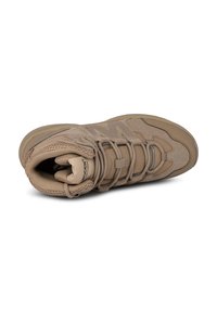 Tan high-top sneaker featuring a textured upper, padded collar, and durable rubber sole. Decorative stitching and lacing accents.