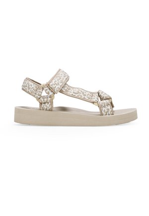 Beige sandal with patterned fabric straps and a flat, textured rubber sole. Two adjustable straps secured with hardware for fit.