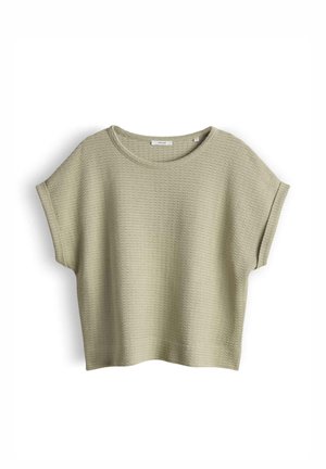 Top beige a maniche corte in tessuto waffle con scollatura tonda e vestibilità comoda, mostrato disteso su uno sfondo bianco.