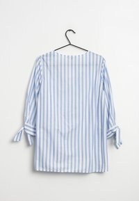 Kevyt, sinivalkoraidallinen paita. Sisältää kolme neljännestä hihoista, joissa on sidottavat hihansuut, sekä pyöreän kaula-aukon. Puuvillakangasta.