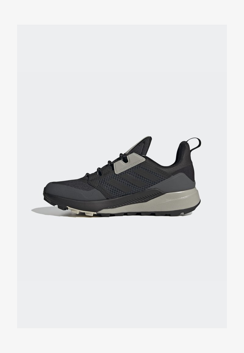 Black athletic shoe with a textured mesh upper, reinforced toe, gray accents, lace-up closure, and durable rubber sole.