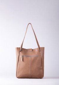 Brown leather tote bag with two long straps, front zip pocket, smooth texture, and clean lines. Features silver stitching accents.