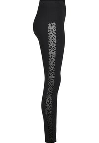 Sorte leggings med en gjennomsiktig panel som har et svart leopardmønster langs yttersiden, elastisk materiale og høy midje.