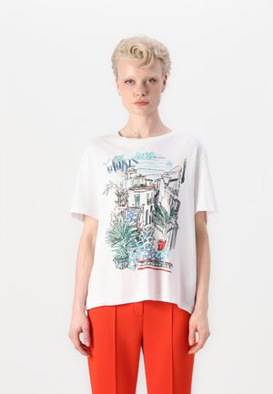 White cotton t-shirt featuring a colorful graphic print of Mediterranean architecture and plants. Loose fit, with short sleeves and a round neckline.
