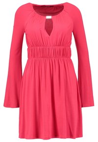 Robe rose à manches longues avec un décolleté en trou de serrure et une taille élastique. Fabriquée en tissu doux qui tombe doucement, longueur genou.