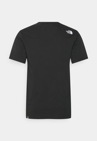 Czarna koszulka z krótkim rękawem z mieszanki bawełny, z okrągłym dekoltem i małym białym logo na górnej części pleców. Gładka faktura.