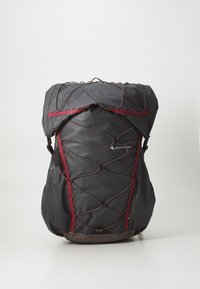 Black backpack made of durable fabric, featuring red accent lines and a bungee cord design, with adjustable straps and a structured shape.