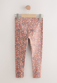 Blomstrede leggings i brunt stof med pinke og blå blomster; strækbart materiale med en tætsiddende pasform og ankellængde.