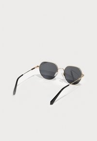 Octagonal sunglasses with gray lenses, gold metal frame, black plastic temple arms, and clear nose pads. Lightweight design.