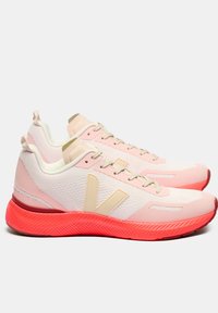 Lightweight athletic shoes with a pink mesh upper and cream accents, featuring a textured red outsole and a large side logo.