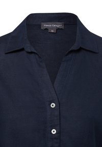 Dark blue, collared shirt with a v-neck, featuring a button-up front, smooth texture, and labeled with "Franco Callegari" and size 36.