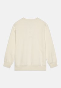 Krämsfärgad sweatshirt med långa ärmar, rund halsringning och ribbade mudd och nederkant. Mjuk tygtextur med minimalistisk design.