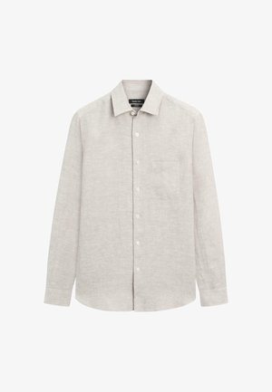 Chemise beige clair à manches longues avec boutons, col et poche poitrine, en tissu texturé.