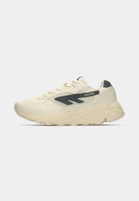 Cream-colored sneaker with a textured upper, contrasting dark gray accent, and a thick sole. Features flat laces and a padded collar.