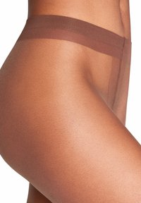 Collant marroni trasparenti con una texture liscia, dotati di una fascia in vita ampia e morbida. Il materiale appare leggero e aderente.
