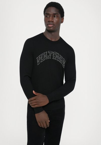 Black sweater with a crew neckline, featuring a "VOLTAIRE" graphic in gray across the chest. Made of soft, ribbed material. Long sleeves.