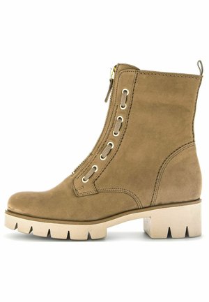 Brown suede ankle boot with a side zipper, lace accents, and a chunky beige sole featuring a textured pattern.
