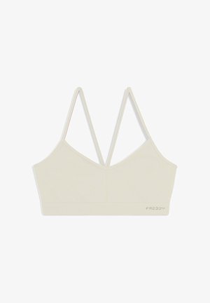 Beige lyhyt bralette, jossa on ribbitekstuuri, säädettävä kaksinkertainen hihna ja V-mallinen kaula-aukko. Alhaalla on brodeerattu logo.