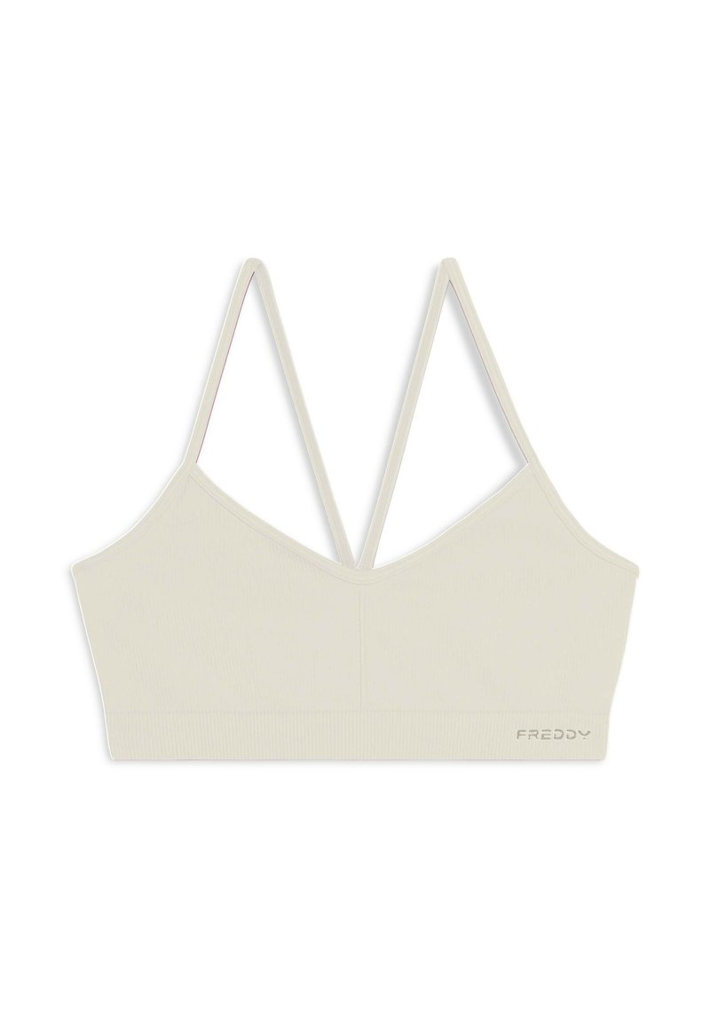 Bralette cropped beige con texture a coste, spalline doppie regolabili e scollatura a V. Presenta un logo ricamato sul fondo.