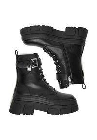 Black leather ankle boots with thick platform soles, lace-up front, side zipper, adjustable strap with a buckle, and textured rubber outsole.