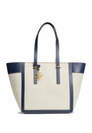 Sac cabas en toile beige avec garniture et anses en cuir bleu marine, avec un porte-monogramme doré sur la sangle avant.