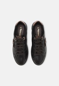 Black leather shoes with brown accents, featuring a thick sole, round toe, and standard laces. Size 37 indicated on the insole.