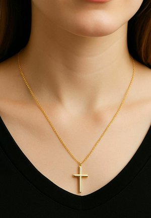 Gold-tone pendant necklace featuring a polished cross design suspended from a delicate twisted chain, worn over a black v-neck top.