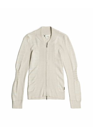 Light beige zip-up cardigan with a ribbed texture, featuring wide cuffs, a banded collar, and two front pockets.