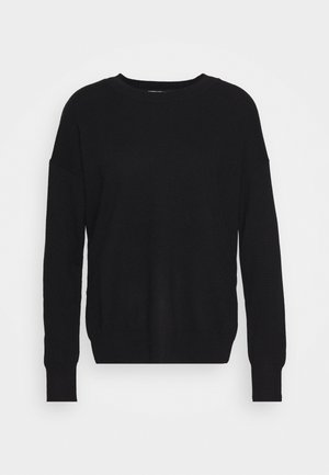 Black knitted sweater with a round neckline, long sleeves, and a relaxed fit. Features ribbed cuffs and hem, with a soft texture.