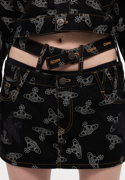 Black denim crop jacket and skirt featuring white printed graphics of circular shapes with crosses. Yellow stitching accents visible.