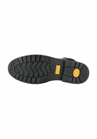 Suela de bota de goma negra con patrones de relieve profundos, que presenta un acento en forma de círculo amarillo y secciones texturizadas para agarre.