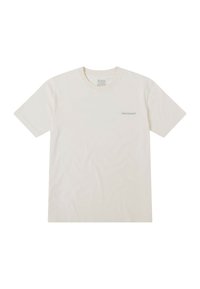 Camiseta corta de manga con cuello redondo en color crema, fabricada en algodón. Presenta un sutil logo en gris en la parte izquierda del pecho.