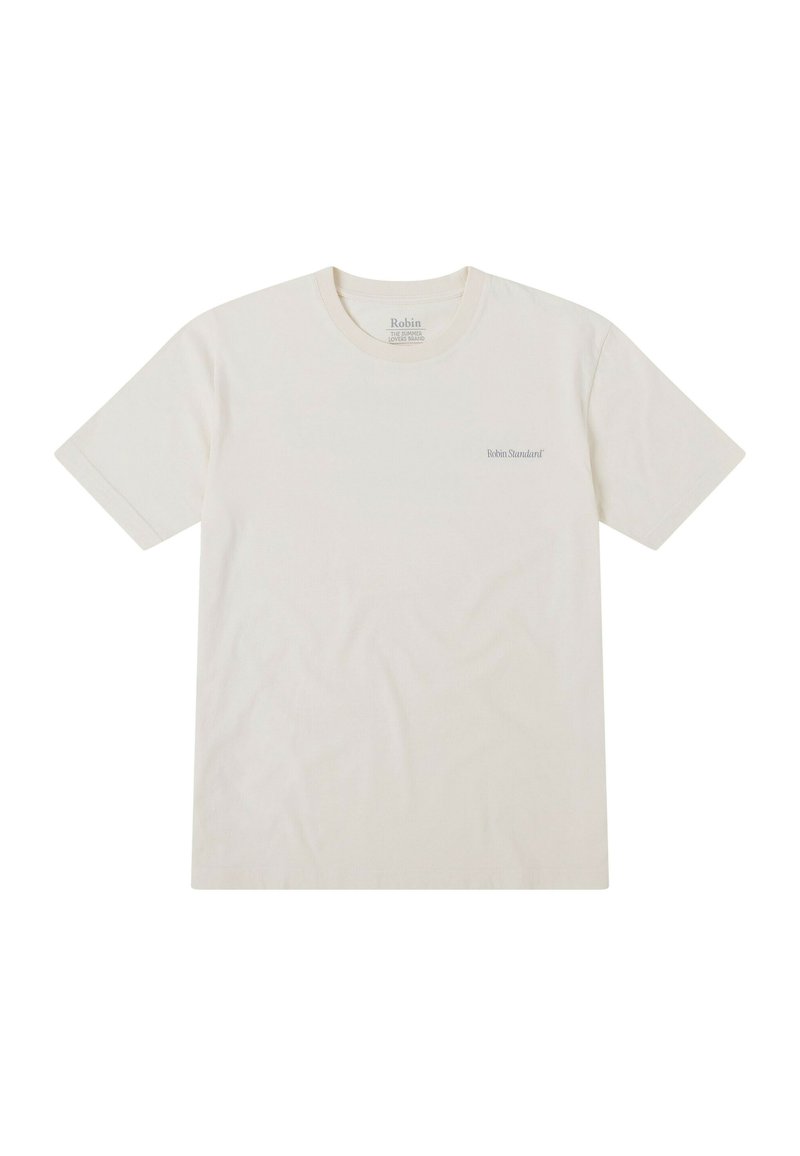Camiseta corta de manga con cuello redondo en color crema, fabricada en algodón. Presenta un sutil logo en gris en la parte izquierda del pecho.