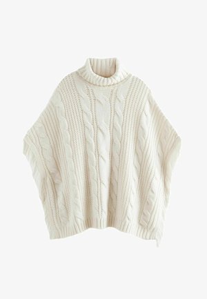 Cable-knit poncho in cream with a high ribbed collar. Features textured patterns and fringed edges. Soft knit material with a loose fit.