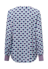 Blusa a maniche lunghe con un motivo occhi multicolore, tessuto morbido, orlo curvo e polsini a righe con una vestibilità rilassata.