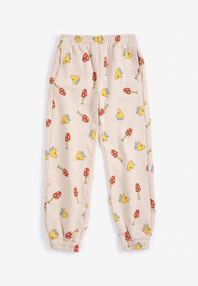 Pantalon de jogging beige à taille élastique avec poignets élastiques et un motif de champignons rouges et jaunes sur l’ensemble.