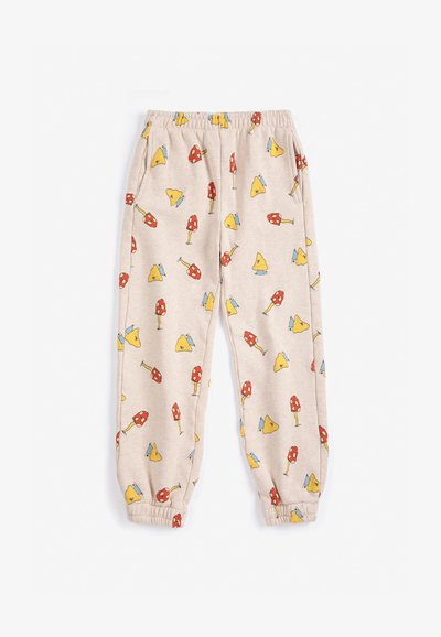 Pantalon de jogging beige à taille élastique avec poignets élastiques et un motif de champignons rouges et jaunes sur l’ensemble.