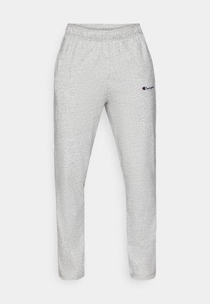 Pantalon de survêtement gris clair avec une taille élastique. Tissu doux et texturé avec un motif subtil. Petit logo brodé en bleu marine.