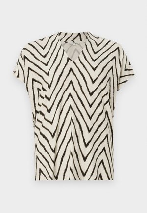 Haut à manches courtes en V crème avec un imprimé zigzag noir. Tissu doux, coupe décontractée et coutures latérales pour plus de structure.