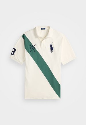 Polo shirt in cream with a diagonal green stripe, featuring navy embroidery of a polo player, "P" logo, and number "3" on the sleeve.