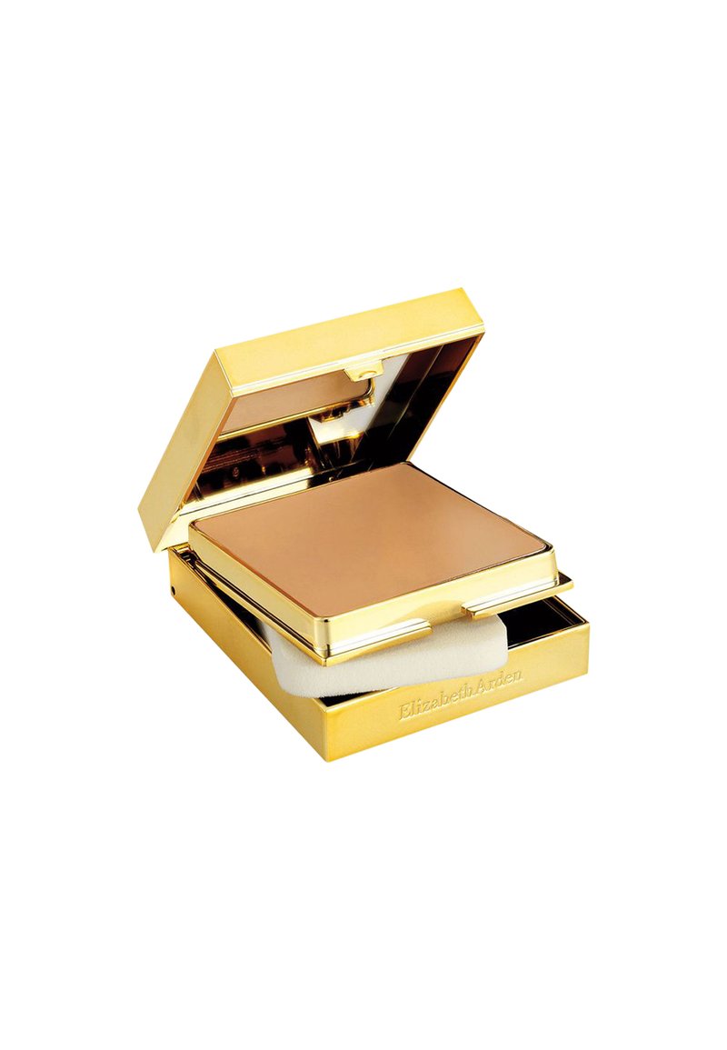 Casetta di cipria in oro con una polvere bronzo opaca e liscia all'interno. Include una spugnetta applicatrice bianca. Interno riflettente.