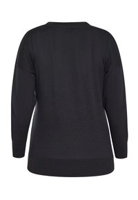 Schwarzer Pullover mit lockerem Schnitt, langen Ärmeln, gerippten Bündchen und Saum, der eine glatte Textur und ein Rundhalsausschnitt-Design aufweist.