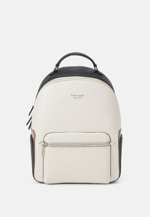 Petit sac à dos en cuir Kate Spade blanc et noir avec poignée supérieure, poche avant zippée et logo doré de la marque à l'avant.